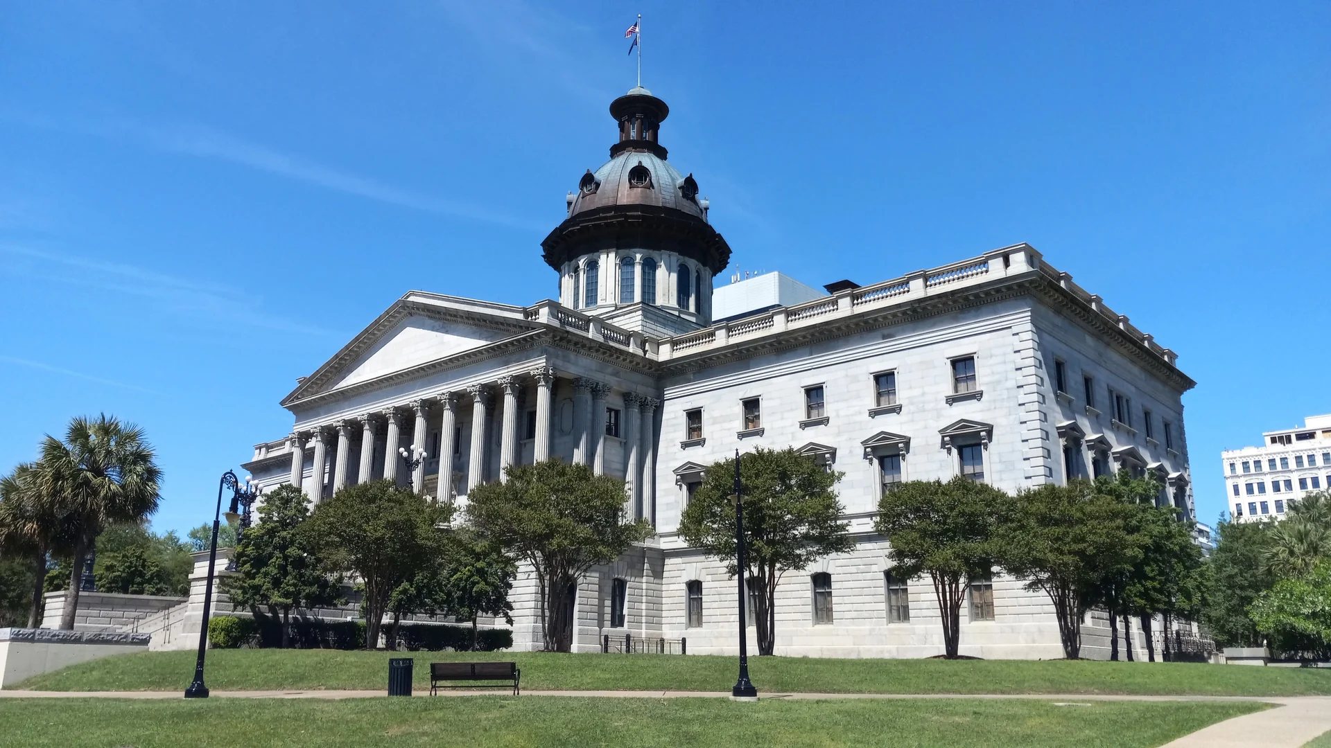 South Carolina State House in Columbia, framed by blue sky and green lawns
